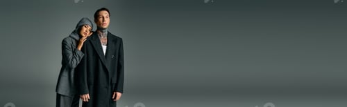 Preview: Young couple poses in stylish attire against a minimalist background in an artistic setting