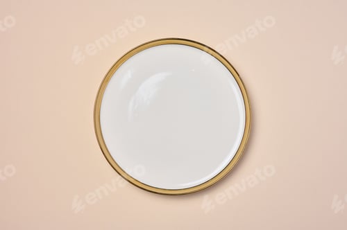 Preview: Empty round ceramic white plate with a gilded edge on a beige background, top view