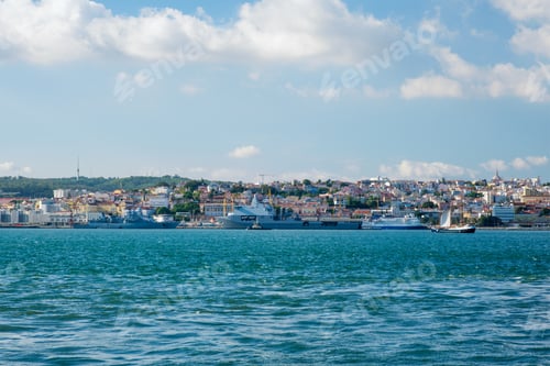 Preview: Tagus river with tourist boat and moored warships in Lisbon, Portugal