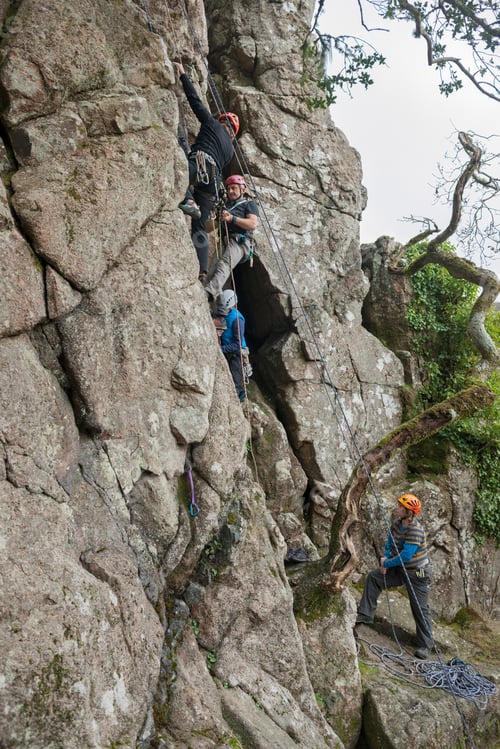Adults Rock Climbing in Rugged Natural Setting