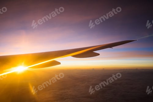 Preview: View of beautiful sunrise and flare outside airplane window