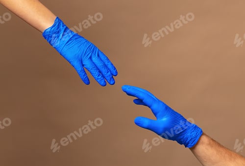 Preview: Male and female hands in medical gloves stretch to each other. Help concept.
