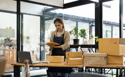 Preview: Startup SME small business entrepreneur SME or freelance Asian woman using a laptop with box