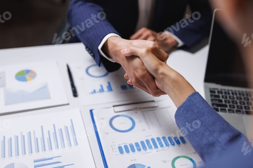 Preview: Business partners shaking hands signing financial agreement