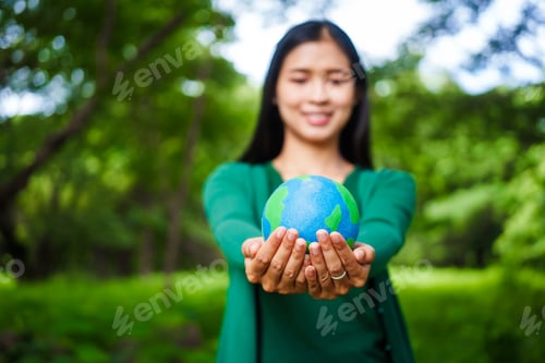 Preview: A male hand holds a hammer, symbolizing the enforcement of tree conservation laws. This highlights