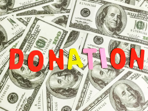Preview: Top view word donation on dollar bank notes.