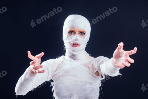 Preview: Glamorous mummy woman in bandages all over her body studio black background