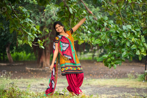 Preview: Beautiful girl between nature full of branches of tree.