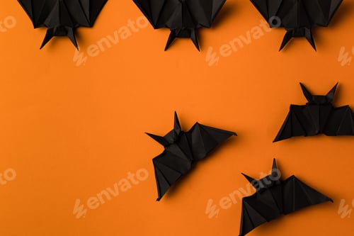 Preview: black origami bats for halloween, isolated on orange with copy space
