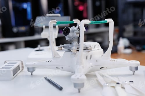 Preview: Workshop for the repair of electronic drones. A broken aircraft is being repaired by a specialist.