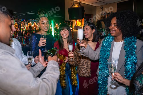 Preview: Diverse friends celebrating with champagne at a vibrant party