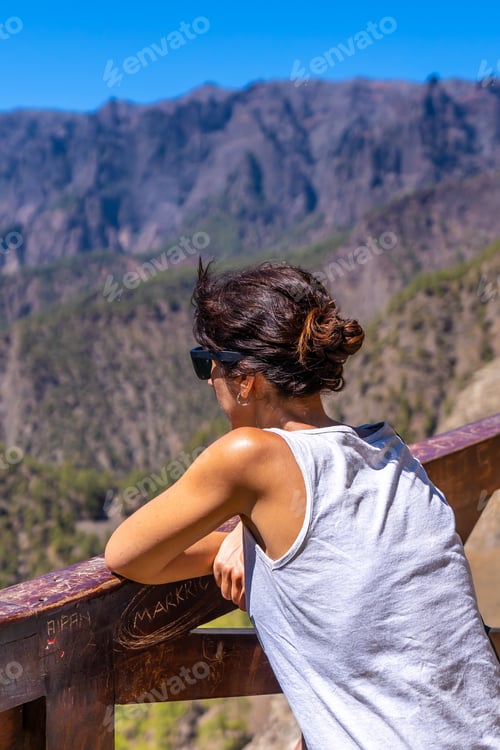 Preview: A young tourist looking at the landscape at the Mirador de los Roques on the La Cumbrecita