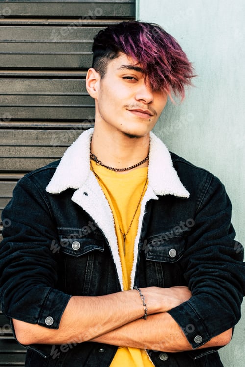 Preview: One young guy teenager standing against a wall and garage door looking on camera