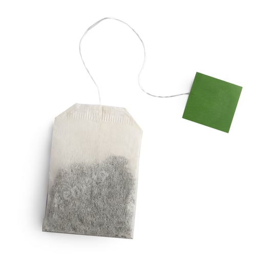 Preview: Paper tea bag with tag isolated on white, top view