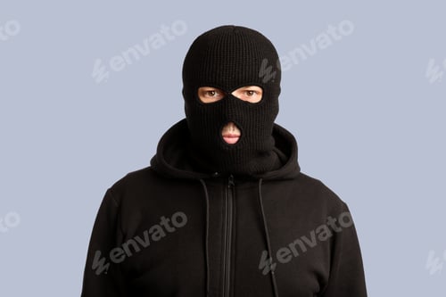 Preview: Portrait of masked thief isolated over white studio wall