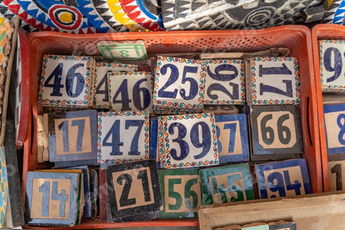 Preview: Top view of a lot of stones with numbers painted on them in an old Moroccan style
