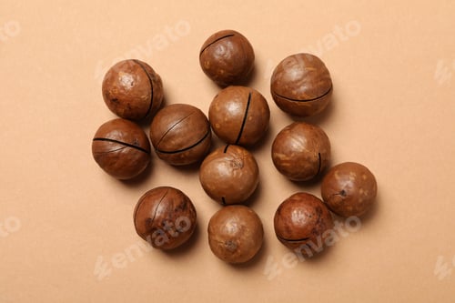 Preview: Group of tasty macadamia nuts on beige background