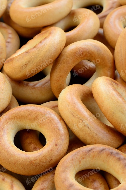 Preview: Close-up photo of fresh yellow bagels. A popular kind of flour products. One of the