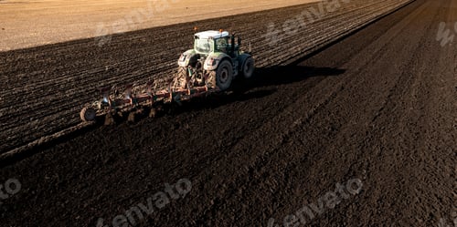 Preview: a tractor ploughing a fertile field with rich soil