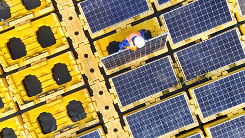 Preview: Men technicians mounting photovoltaic solar at floating solar station