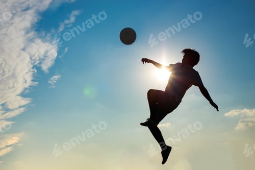 Preview: Silhouette action sport outdoors of football players on the sunset sky. Athlete man jumping kick soc