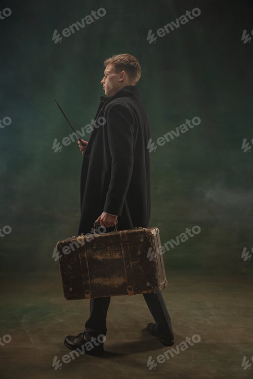 Preview: Young man in art action isolated on dark green background. Retro style, comparison of eras concept