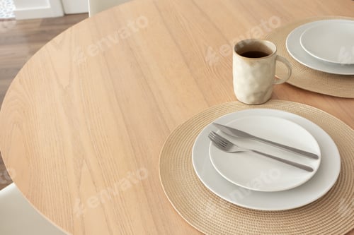 Preview: Neutral table setting with coffee mug on wooden table in dinning room, close-up