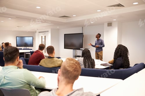 Preview: University students study in a classroom with male lecturer