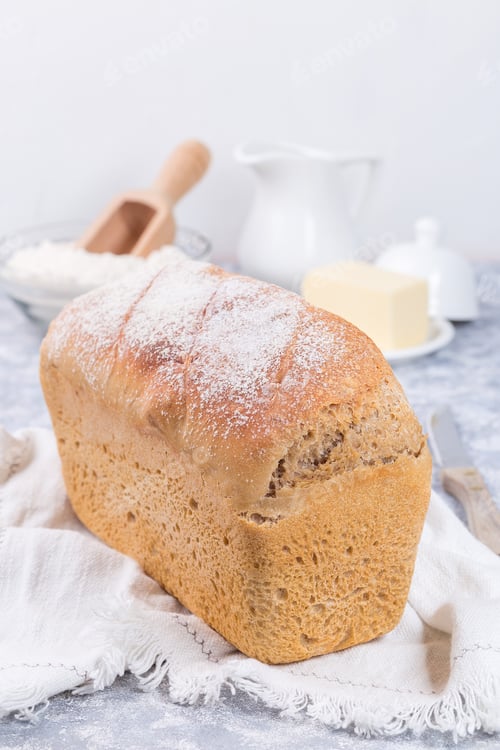 Preview: Loaf of homemade no knead sandwich bread with white cloth, vertical