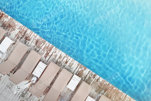 Preview: Sun lounge chairs near swimming pool, top view