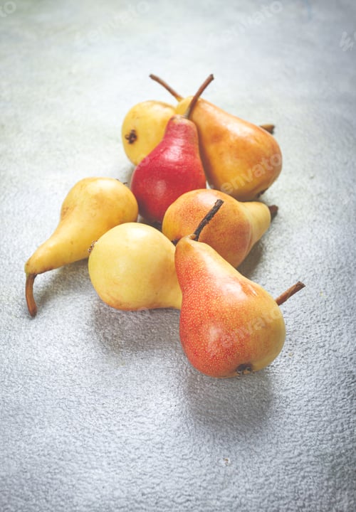 Preview: small pears, Duchess variety, scattered on the table, top view, no people,