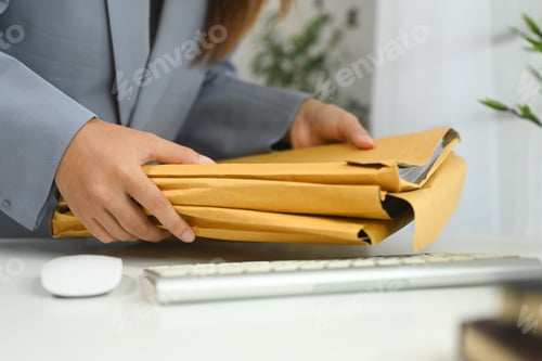Preview: Cropped shot office worker managing document folders in office