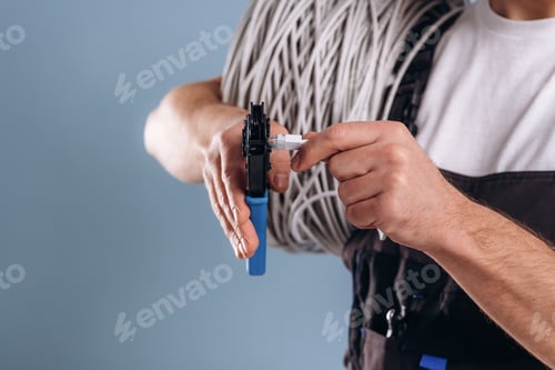 Preview: Cables in hands. Close up view of man against background