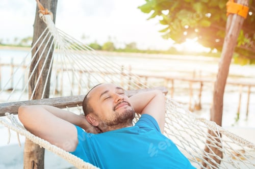 Preview: Relaxing Man in Hammock on Tropical Beach