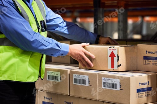 Preview: Shot of a unrecognizable man packing boxes in a warehouse