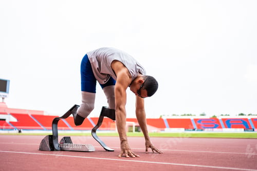 Preview: Asian para-athletes disabled with prosthetic blades running at stadium.
