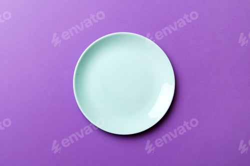 Preview: Top view of isolated of colored background empty round blue plate for food.