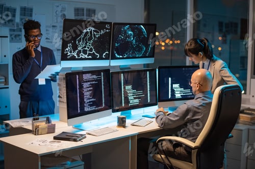 Preview: Two colleagues sitting in front of computer monitors with decoded data