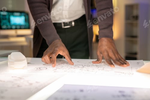 Preview: Examining car sketch in office