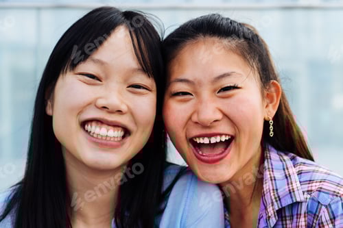 Preview: Happy beautiful chinese women friends bonding in the city