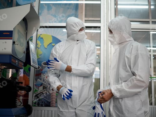 Preview: Workers in Protective Suits Inspecting Industrial Equipment