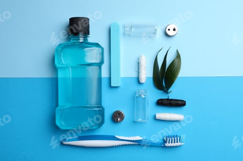Vista previa: Different oral hygiene products on color background, flat lay