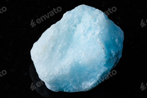 Preview: sample of raw blue aragonite rock on black granite