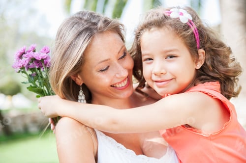Preview: Smiling Woman and Girl Hugging with Flowers