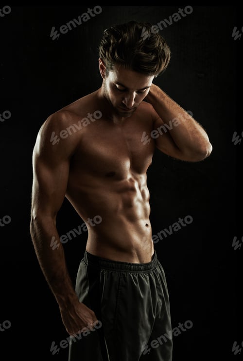 Preview: Dedication Super body. Gorgeous man with a sculpted body isolated on black.