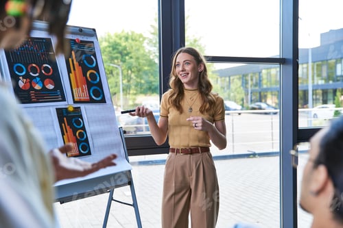 Preview: businesswoman pointing at flip chart with infographics near multiethnic team in modern office