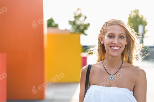 Preview: happy beautiful blonde woman smiling looking at the camera and posing