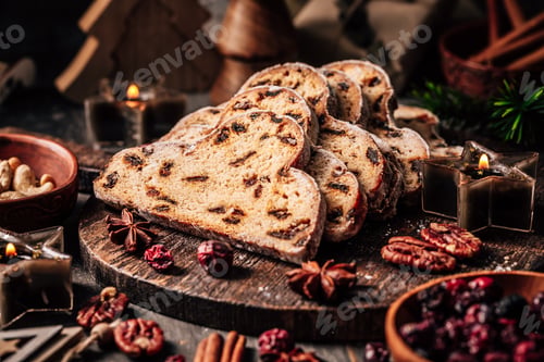 Preview: Traditional christmas stollen fruit cake with cookies on festive table