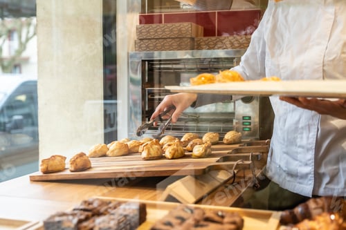 Preview: Baker arranging fresh empanadas in a pastry shop display