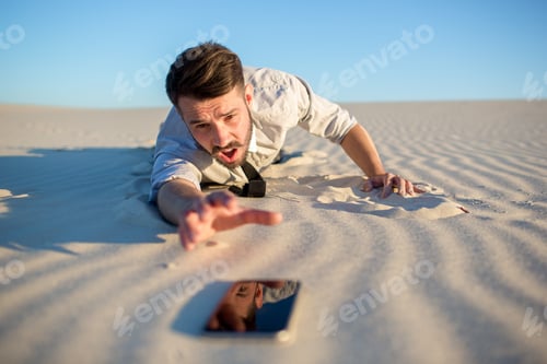 Preview: Poor signal. businessman searching for mobile phone signal in desert